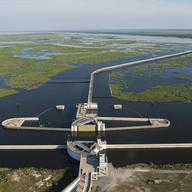 A storm surge barrier in New Orleans. During heavy weather, the green gates on either side of the channel swing closed.