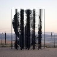 When the steel columns align, they reveal the face of Nelson Mandela. 