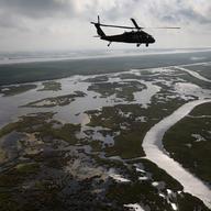  A Louisiana National Guard blackhawk flies over marshland on April 19, 2011 in route to Middle Ground in southern Louisiana. 