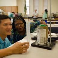 Science teachers conduct an experiment in a workshop on Modeling Instruction at Columbia's Teachers College.