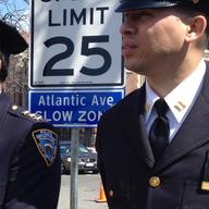 Police officers wear black bands on their shields to honor Housing Officer Dennis Guerra, 36, who died of smoke inhalation. He was investigating a fire in a Coney Island public housing high rise.