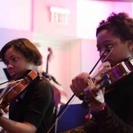 Students from the Summer Arts Institute play instruments donated during WQXR's drive.