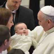 Pope Francis holds a baby at the end of his weekly general audience at the Paul VI hall on January 7, 2015 at the Vatican.