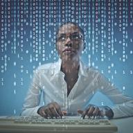 Girl coding on her computer.