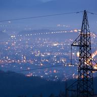 power lines with city lights in the background