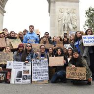 College students pose with signs in front of Washington Square arch prior to marching on October 24th, 2015.