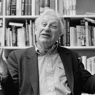 Studs Terkel celebrating after winning the 1985 Pulitzer Prize for his novel, 'The Good War,' inside his office at WFMT-FM Studio in Chicago.