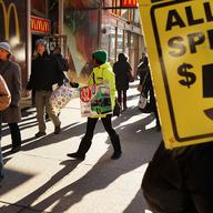 Sightseeing vendors look for tourists in Times Square on December 11, 2013 in New York City. The tourism industry is a fast-growing aspect of the economy.
