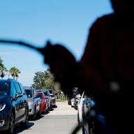 In this Sept. 13, 2017, file photo, cars wait in line for gas as a station in Miromar Lakes, Fla.