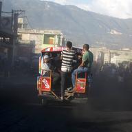 A tap-tap bus carrying commuters makes its way through the street on the second day of a national, general strike in Port-au-Prince, Haiti, early Tuesday, July 10, 2018.