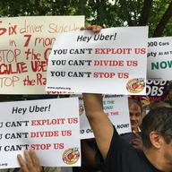 Members of 32BJ and the Taxi Worker's Alliance rally outside of City Hall in support of a series of bills that would be the first in the country to regulate ride haling apps.