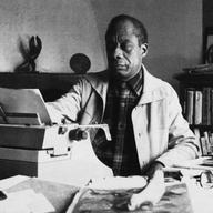American writer James Baldwin poses in front of his typewriter in his house, March 15, 1983, Saint Paul de Vence, France.
