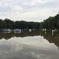 In a Saturday, Aug. 11, 2018 photo, a supermarket parking lot is flooded from rainfall in Little Falls, N.J.