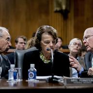 Senate Judiciary Committee Chairman Chuck Grassley, R-Iowa, left, accompanied by Sen. Dianne Feinstein, D-Calif., the ranking member, center, speaks with Sen. Patrick Leahy, D-Vt., right.