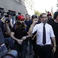 Gavin McInnes is surrounded by supporters after speaking at a rally Thursday, April 27, 2017, in Berkeley, Calif. McInnes, co-founder of Vice Media and founder of the pro-Trump 'Proud Boys,'