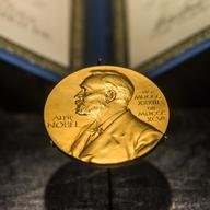 Nobel Prize in front of diploma