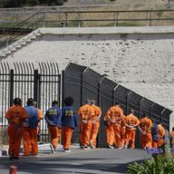 In this Aug. 16, 2016 photo, a row of general population inmates walk in a line at San Quentin State Prison in San Quentin, Calif. 