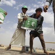 In this Saturday, Feb. 3, 2018 photograph, relief workers unload aid carried into Yemen by the Saudi military in Marib, Yemen. Saudi Arabia,
