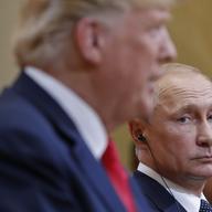 Russian President Vladimir Putin, right, looks over towards U.S. President Donald Trump, left, as Trump speaks during their joint news conference at the Presidential Palace in Helsinki