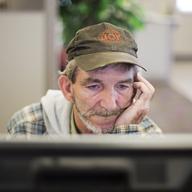 In this Oct. 20, 2014 photo, unemployed coal miner Eddie Jones looks for jobs on a computer at the Kentucky Career Center in Harlan, Ky. 