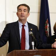 Virginia Gov. Ralph Northam, left, accompanied by his wife, Pam, speaks during a news conference in the Governor's Mansion in Richmond, Va.