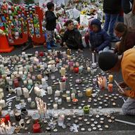 Students light candles as they gather for a vigil to commemorate victims of Friday's shooting, outside the Al Noor mosque in Christchurch, New Zealand, Monday, March 18, 2019.