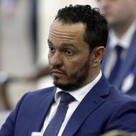 Albert Alvarez listens to a question as he testifies before the joint legislative oversight committee.