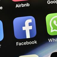  In this Nov. 15, 2018, file photo the icons of Facebook and WhatsApp are pictured on an iPhone in Gelsenkirchen, Germany.