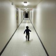 An asylum-seeking boy from Central America runs down a hallway after arriving from an immigration detention center to a shelter in this 2018 file photo.
