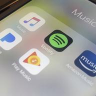 This Jan. 28, 2018, file photo shows music streaming apps clockwise from top left, Apple, Spotify, Amazon, Pandora and Google on an iPhone in New York.