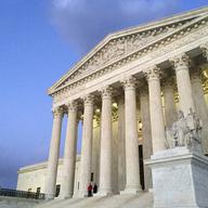 In this Feb. 13, 2016, file photo, people stand on the steps of the Supreme Court at sunset in Washington. 
