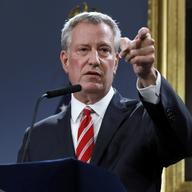New York Mayor Bill de Blasio calls on a member of the press at City Hall