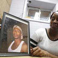 Veronica Parker holds a photo of her late son, Korey B. Parker, Sr., 27, at her workplace. Parker is a member of Purpose Over Pain, a support group for parents who've lost children to gun violence.
