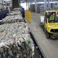 In this Thursday, Oct. 13, 2016, photo, recycled plastic bottles sit on a conveyor belt to be processed at the Repreve Bottle Processing Center.