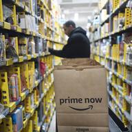 In this Dec. 20, 2017, file photo, a clerk reaches to a shelf to pick an item for a customer order at the Amazon Prime warehouse in New York.