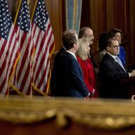 As seen in reflection, Chairman of the House Committee on the Judiciary Jerrold Nadler, D-N.Y. and other House Democratic leaders unveil articles of impeachment against President Trump, Dec. 10 