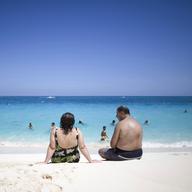 Tourists sunbathe along the beach in Nassau, Bahamas, Saturday, Sept. 6, 2008.