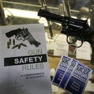 In this Feb. 23, 2016 file photo, gun safety and suicide prevention brochures are on display next to guns for sale at a local retail gun store in Montrose Colo. 
