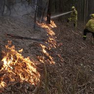 Firefighters manage a controlled burn to help contain a larger fire near Falls Creek, Australia, Sunday, Jan. 5, 2020. 