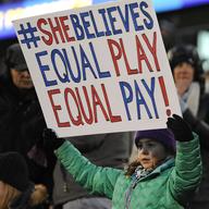  In this April 6, 2016, file photo, a girl holds up a sign for equal pay for the U.S. women soccer players.
