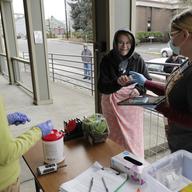 In this March 27, 2020 photo, Laura Spracklin, center, picks up medication for opioid addiction at a clinic in Olympia, Wash.