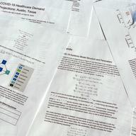 A report delivered on COVID-19 health care demand is photographed.