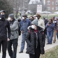 Voters line up observing social distancing at Riverside High School for Wisconsin's primary election Tuesday April 7, 2020, in Milwaukee. 