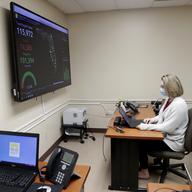 In this Wednesday, May 13, 2020 photo, Meghan Peck works on contact tracing at the Florida Dept. of Health in Miami-Dade County, during the new coronavirus pandemic, in Doral, Fla.