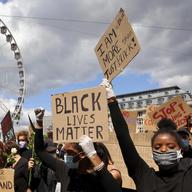Protesters hold placards during the Black Lives Matter protest rally in Brussels, Sunday, June 7, 2020. The demonstration was held in response to the recent killing of George Floyd by police officers