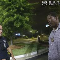 This screen grab taken from body camera video provided by the Atlanta Police Department shows Rayshard Brooks speaking with Officer Garrett Rolfe in the parking lot of a Wendy's restaurant.