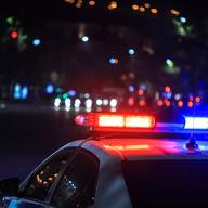 police car's red and blue lights shining at night in street