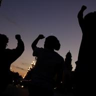 People raise their fists Tuesday, June 23, 2020, in Kansas City, Mo., during a protest over the death of Black people at the hands of police. 