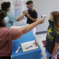 Amid concerns of the spread of COVID-19, science teachers Ann Darby, left, and Rosa Herrera check-in students before a summer STEM camp at Wylie High School Tuesday, July 14, 2020, in Wylie, Texas.
