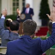 Reporters raise their hands to ask questions as President Donald Trump speaks during a news conference in the Rose Garden of the White House, Tuesday, July 14, 2020, in Washington.